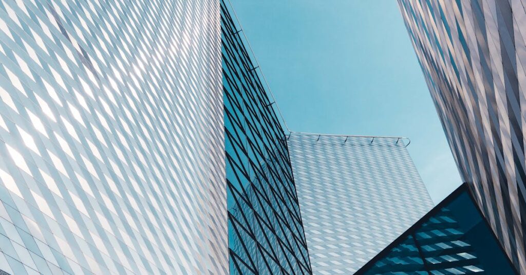 Futuristic skyscrapers in Vilnius with reflective geometric facades under a clear sky.